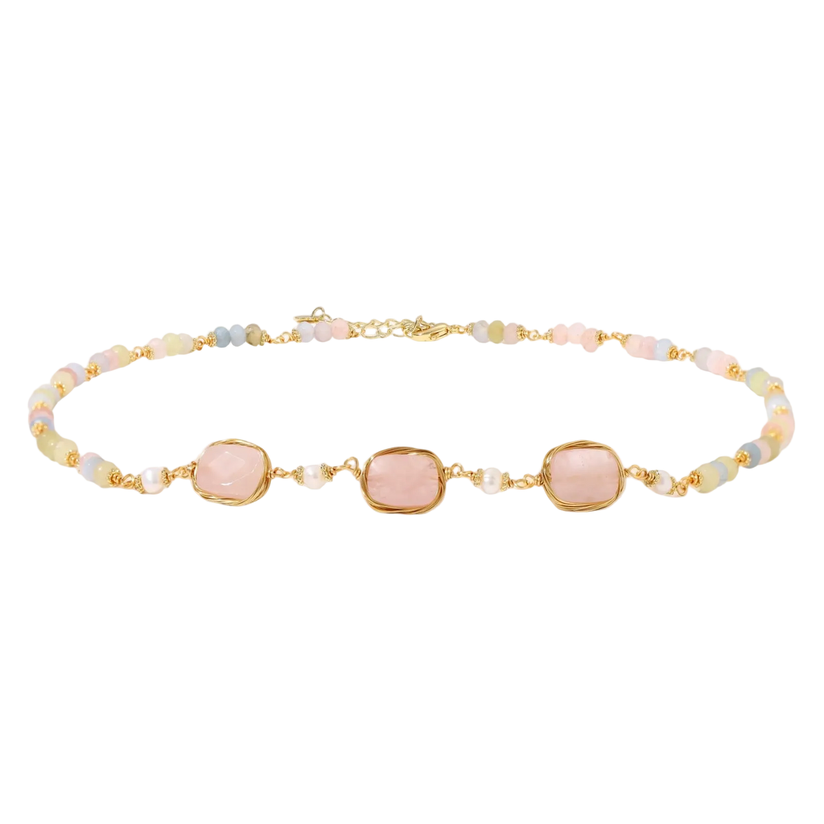 Gold necklace with three rose quartz stones, multicolor pastel beads, and pearl accents on white background.