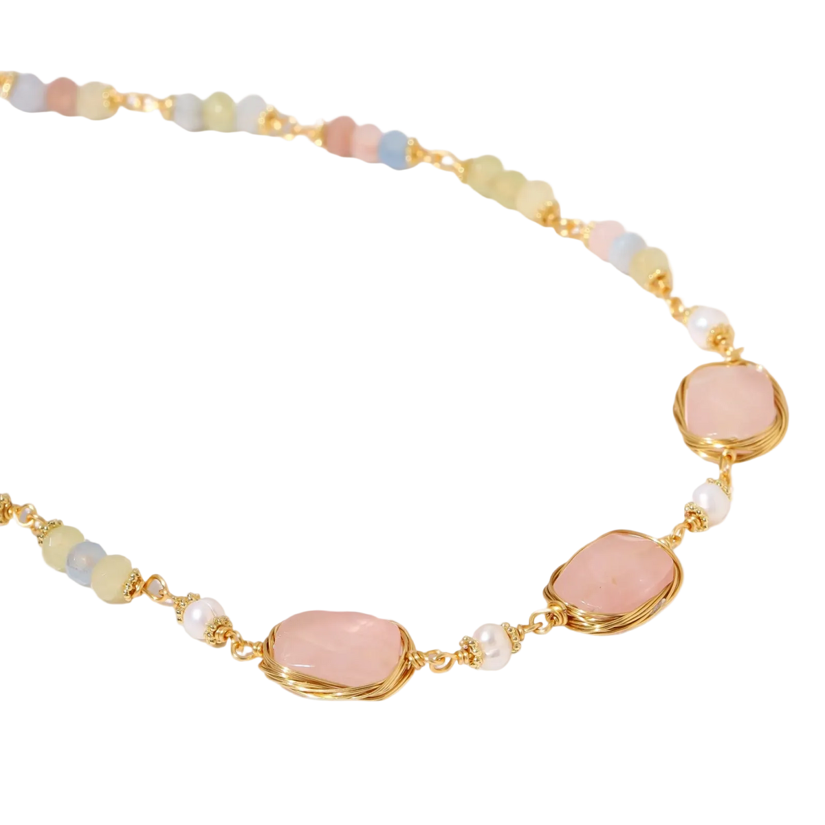 Gold necklace with three rose quartz stones, multicolor pastel beads, and pearl accents on white background.